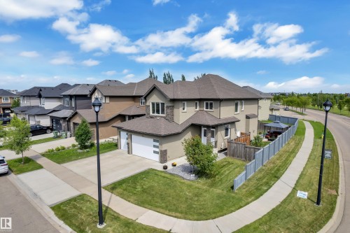 Contemporary home featuring a light stucco exterior, stone accents, and a two-car garage - 3001 55 Street, Beaumont, AB - Outdoor With Facade