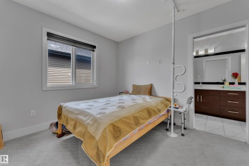 Windowed room with light gray walls, white trim, and light gray patterned carpeting - 3001 55 Street, Beaumont, AB - Indoor Photo Showing Bedroom