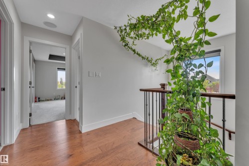 Upper-level hallway featuring wood-finish flooring, recessed lighting, and white baseboards - 3001 55 Street, Beaumont, AB - Indoor Photo Showing Other Room