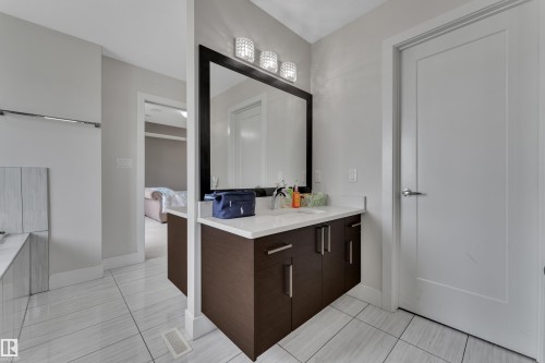 Bathroom featuring a dark wood-finish vanity with a white countertop and rectangular undermount sink - 3001 55 Street, Beaumont, AB - Indoor Photo Showing Other Room