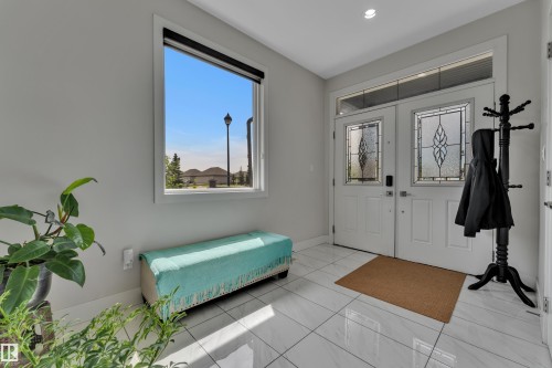 Double front entry doors with decorative glass panels and a transom window - 3001 55 Street, Beaumont, AB - Indoor Photo Showing Other Room