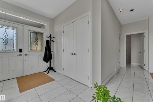 Entryway featuring a double door entrance with decorative glass inserts and a transom window - 3001 55 Street, Beaumont, AB - Indoor Photo Showing Other Room