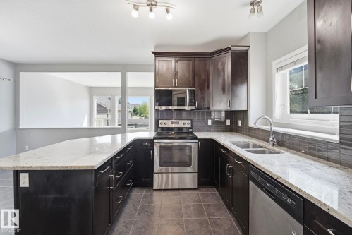 7043 22 Avenue Sw, Edmonton, AB - Indoor Photo Showing Kitchen With Stainless Steel Kitchen With Double Sink With Upgraded Kitchen