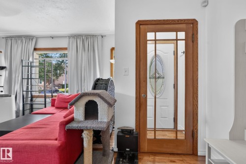 Glass-paneled interior door with wood-finish framing - 12229 88 Street Nw, Edmonton, AB - Indoor