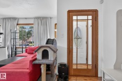 Glass-paneled interior door with wood-finish framing - 