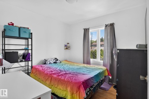Bright room featuring wood-finish flooring, white walls, and a window with natural light - 12229 88 Street Nw, Edmonton, AB - Indoor Photo Showing Bedroom