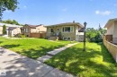 Single-story residence featuring a neutral exterior, concrete walkway, and an expansive front lawn - 12229 88 Street Nw, Edmonton, AB  - Outdoor 