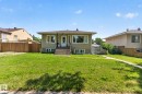 Split-level residence featuring a stucco exterior and a front-facing entry with a security screen door - 12229 88 Street Nw, Edmonton, AB  - Outdoor 