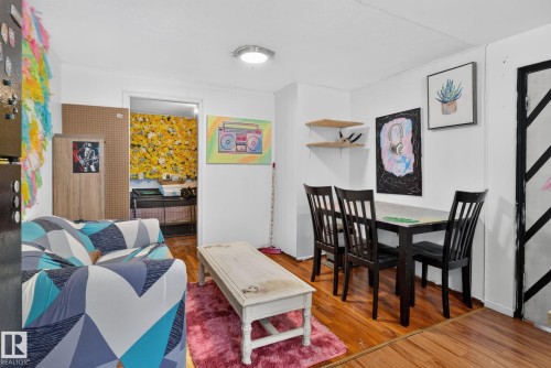 Bright interior space featuring wood-finish flooring and white walls - 12229 88 Street Nw, Edmonton, AB - Indoor