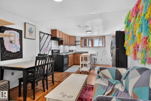 Open-concept living space featuring wood-finish flooring - 12229 88 Street Nw, Edmonton, AB - Indoor