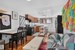 Open-concept living space featuring wood-finish flooring - 