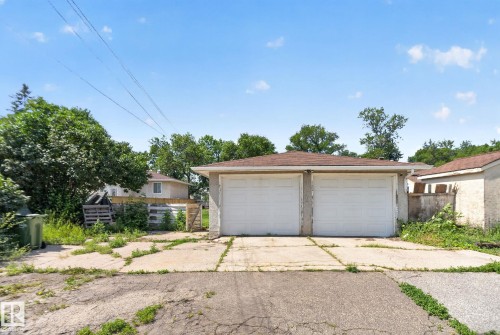 Two-car detached garage with white overhead doors and a shingled roof - 12229 88 Street Nw, Edmonton, AB - Outdoor