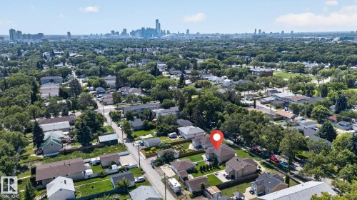 Aerial perspective showcasing the residential area with a prominent city skyline in the distance - 12229 88 Street Nw, Edmonton, AB - Outdoor With View