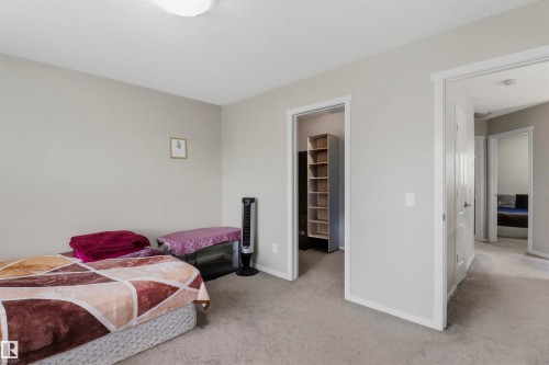 Light gray wall paint complemented by white trim - 1528 35 Avenue Nw, Edmonton, AB - Indoor Photo Showing Bedroom