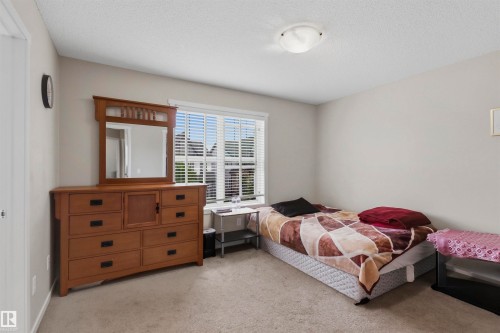 Carpeted room with a ceiling-mounted light fixture and neutral wall color - 1528 35 Avenue Nw, Edmonton, AB - Indoor Photo Showing Bedroom
