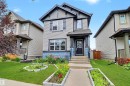Two-story residence featuring light gray siding, dark trim accents, and blue decorative shingles - 1528 35 Avenue Nw, Edmonton, AB  - Outdoor 