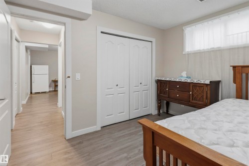 Light-toned wood-finish flooring throughout - 1528 35 Avenue Nw, Edmonton, AB - Indoor Photo Showing Bedroom