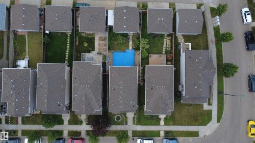 A residential block featuring multiple properties with uniform gray shingle roofs - 1528 35 Avenue Nw, Edmonton, AB - 