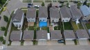 Rear yard featuring a blue-lined pool with surrounding deck, adjacent to a structured patio area - 1528 35 Avenue Nw, Edmonton, AB  - Outdoor With View 