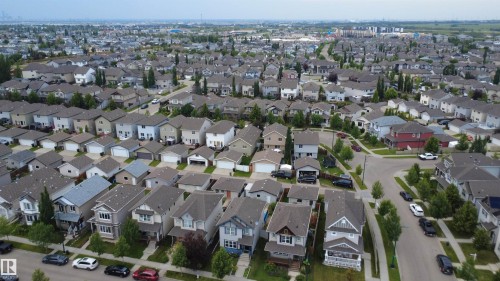 Expansive residential community featuring a variety of detached homes with diverse architectural styles, concrete streets, and mature trees - 1528 35 Avenue Nw, Edmonton, AB - Outdoor With View