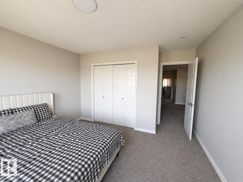 Carpeted room with light neutral wall paint - 1327 20 Nw, Edmonton, AB - Indoor Photo Showing Bedroom