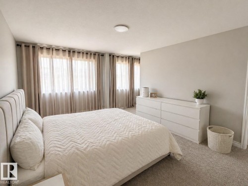 Bedroom featuring light-colored walls and carpeted flooring - 1327 20 Nw, Edmonton, AB - Indoor Photo Showing Bedroom