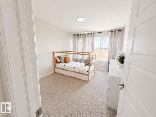 Carpeted room with a single window, recessed lighting, and a white paneled door - 1327 20 Nw, Edmonton, AB - Indoor Photo Showing Bedroom