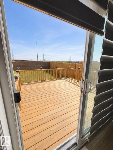 Expansive outdoor deck featuring natural wood planking and a matching wood railing - 1327 20 Nw, Edmonton, AB - Outdoor With Exterior
