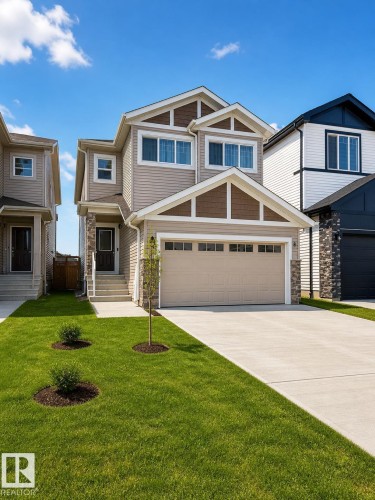 Two-story residence featuring light beige siding with dark brown gables and stone accents - 1327 20 Nw, Edmonton, AB - Outdoor With Facade