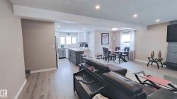 Open-concept living area with wood-finish flooring throughout - 