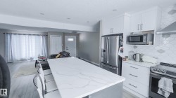 Open-concept living area with wood-finish flooring and recessed lighting - 
