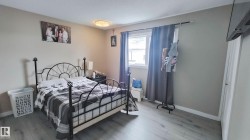 Room featuring wood-finish flooring, a single window, and a ceiling-mounted light fixture - 