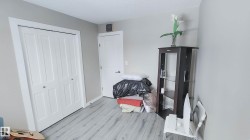 Interior room featuring light gray walls and wood-finish flooring - 