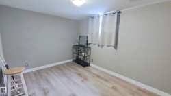 Light wood-finish flooring complements neutral wall tones - 