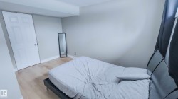 Light wood-finish flooring complements neutral wall tones and white baseboards - 
