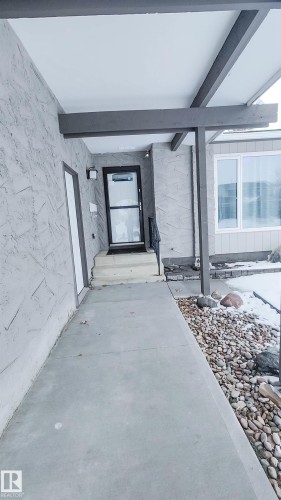 Exterior entry featuring a concrete walkway, stucco facade, and an open beam portico - 3311 108 Street, Edmonton, AB - Outdoor