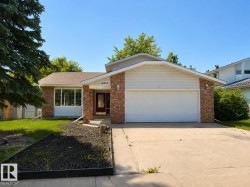 Split-level residence featuring brick and siding exterior, an attached two-car garage, and a concrete driveway - 
