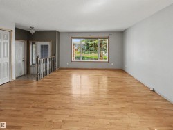 Expansive living area with wood-finish flooring - 