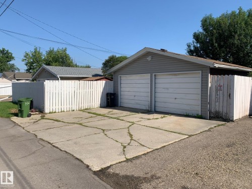 Two-car detached garage featuring horizontal siding and panel garage doors - 16321 - 109A Ave Nw, Edmonton, AB - Outdoor With Exterior