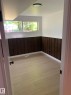 Light wood-finish flooring complements dark wood-paneled wainscoting - 16321 - 109A Ave Nw, Edmonton, AB  - Indoor Photo Showing Other Room 