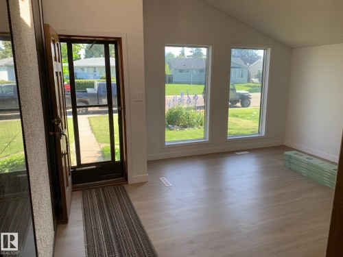 Entry area with light wood-finish flooring and a vaulted ceiling - 16321 - 109A Ave Nw, Edmonton, AB - Indoor Photo Showing Other Room