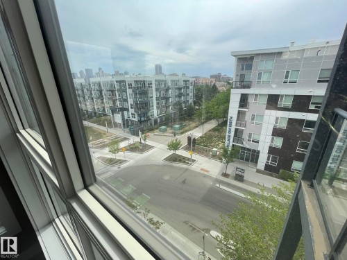 Contemporary multi-pane windows frame a urban streetscape - 504 10518 113 Street, Edmonton, AB - 