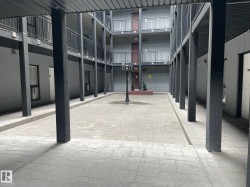 Central courtyard featuring stamped concrete paving and a decorative lamppost - 