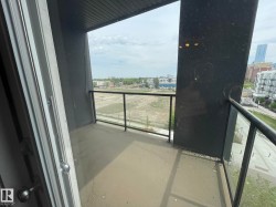 Private balcony with a concrete floor, glass and metal railings, and a wood-panel ceiling - 