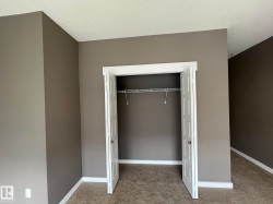 Recessed closet with bi-fold doors, wire shelving, and neutral wall paint - 
