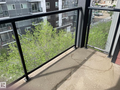 Outdoor balcony space featuring black metal railings with clear glass panels - 504 10518 113 Street, Edmonton, AB - Outdoor With Balcony