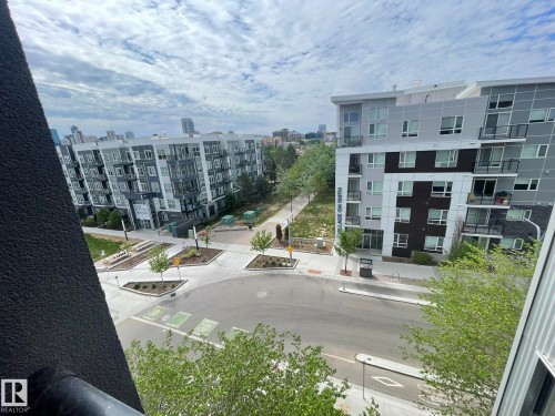 Modern urban streetscape featuring pedestrian pathways, tree-lined sidewalks, and multi-story residential buildings - 504 10518 113 Street, Edmonton, AB - Outdoor With Balcony