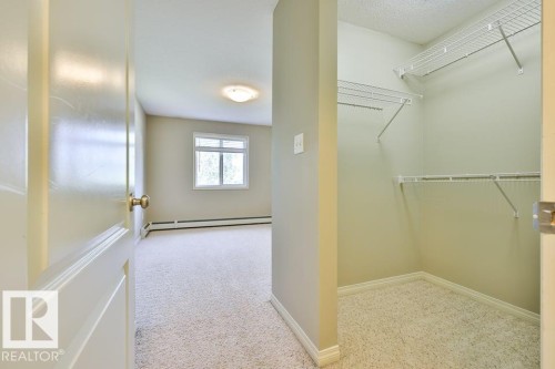 Room featuring light-colored carpeting, white baseboards, and a window with white trim - #406 4903 47 Av, Stony Plain, AB - Indoor