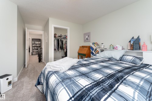 Bedroom featuring light-toned carpeting and neutral wall paint - 16805 55 Street Nw, Edmonton, AB - Indoor Photo Showing Bedroom