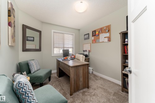 Carpeted room with a textured ceiling and light-colored walls - 16805 55 Street Nw, Edmonton, AB - Indoor Photo Showing Other Room